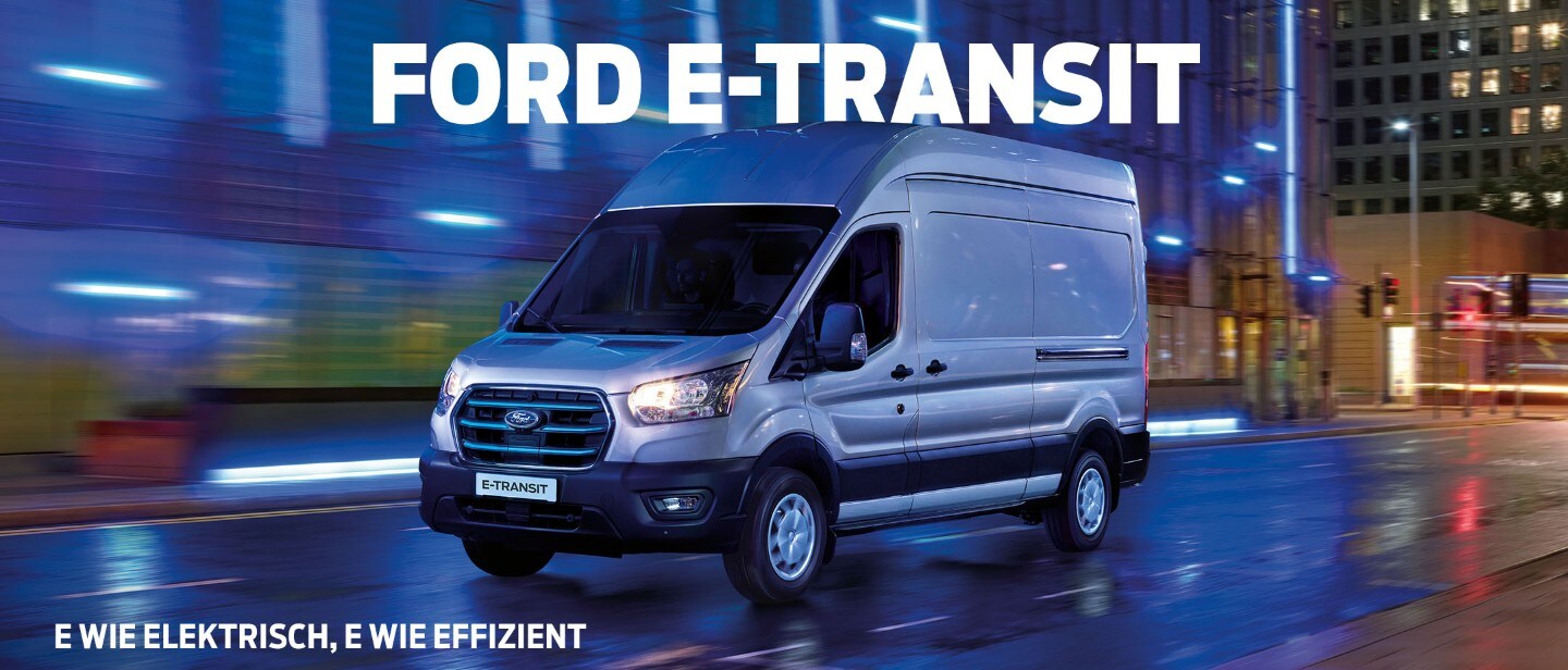 Ford E-Transit in Silber. Dreiviertelansicht, fährt bei Nacht durch eine Stadt