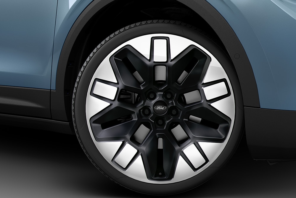 Nahaufnahme von dem Rad eines blauen Ford Elektrofahrzeugs.