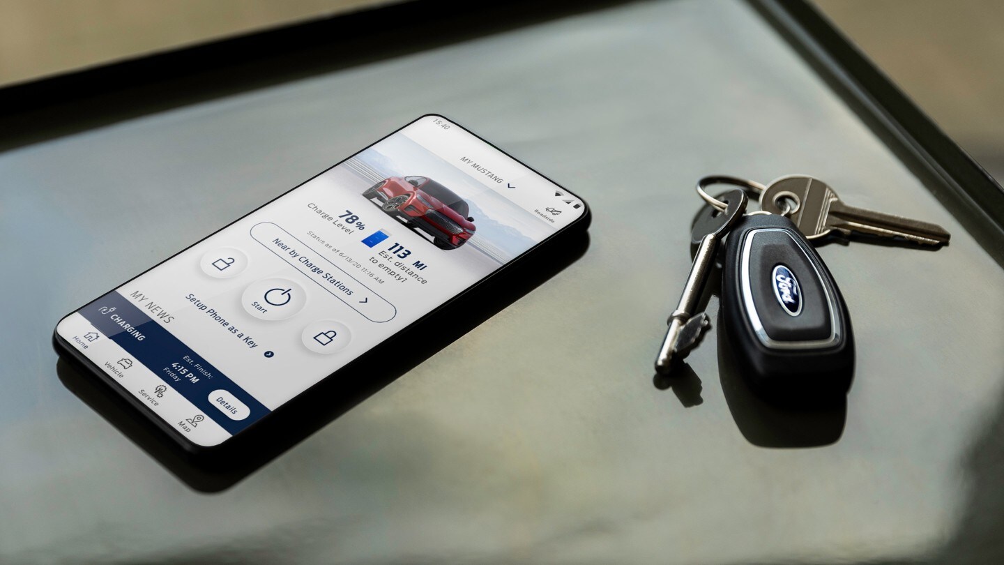 Smartphone mit geöffneter FordPass App und Autoschlüssel daneben