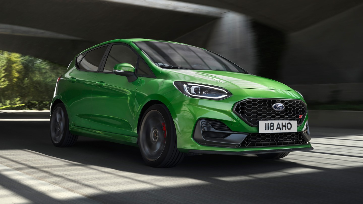 Ford Fiesta ST in Grün. Dreiviertelansicht, unter einer Brücke fahrend.