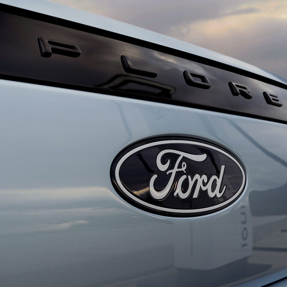 Der vollelektrische Ford Explorer in Blau. Detailansicht Ford-Logo.