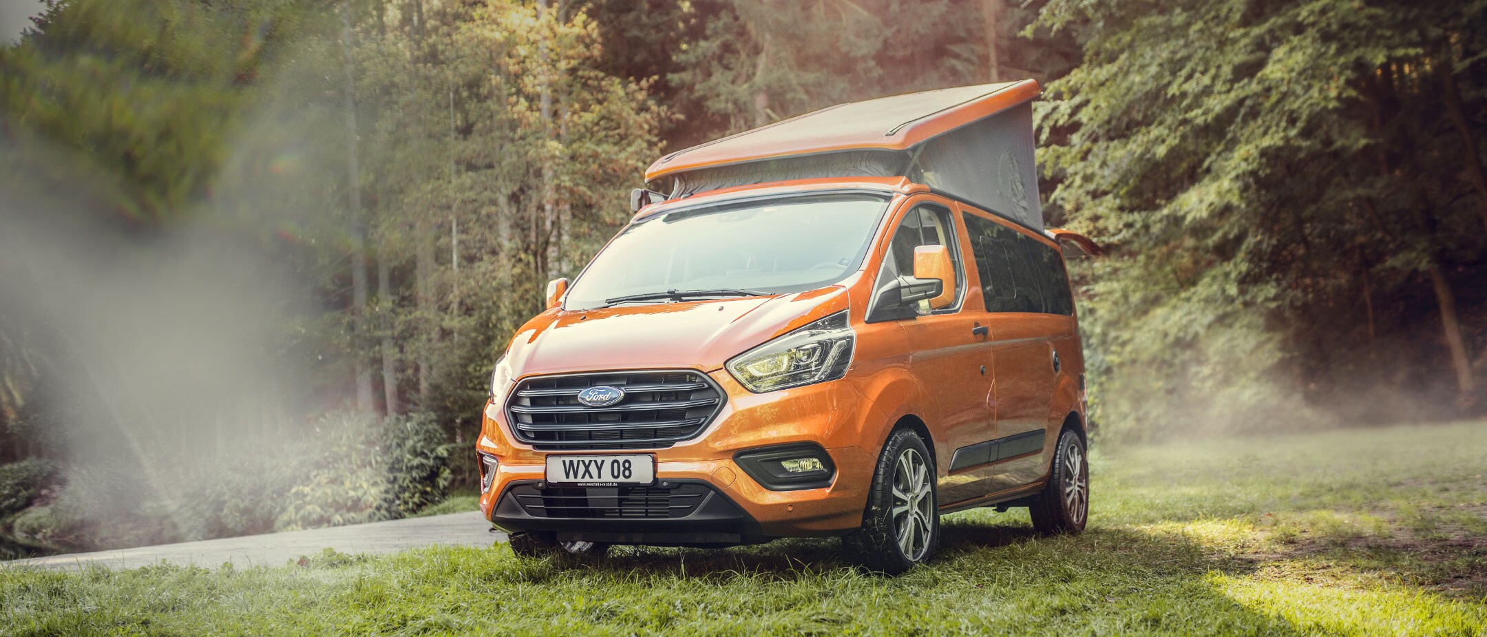 Ford Transit Custom Nugget parked in forest
