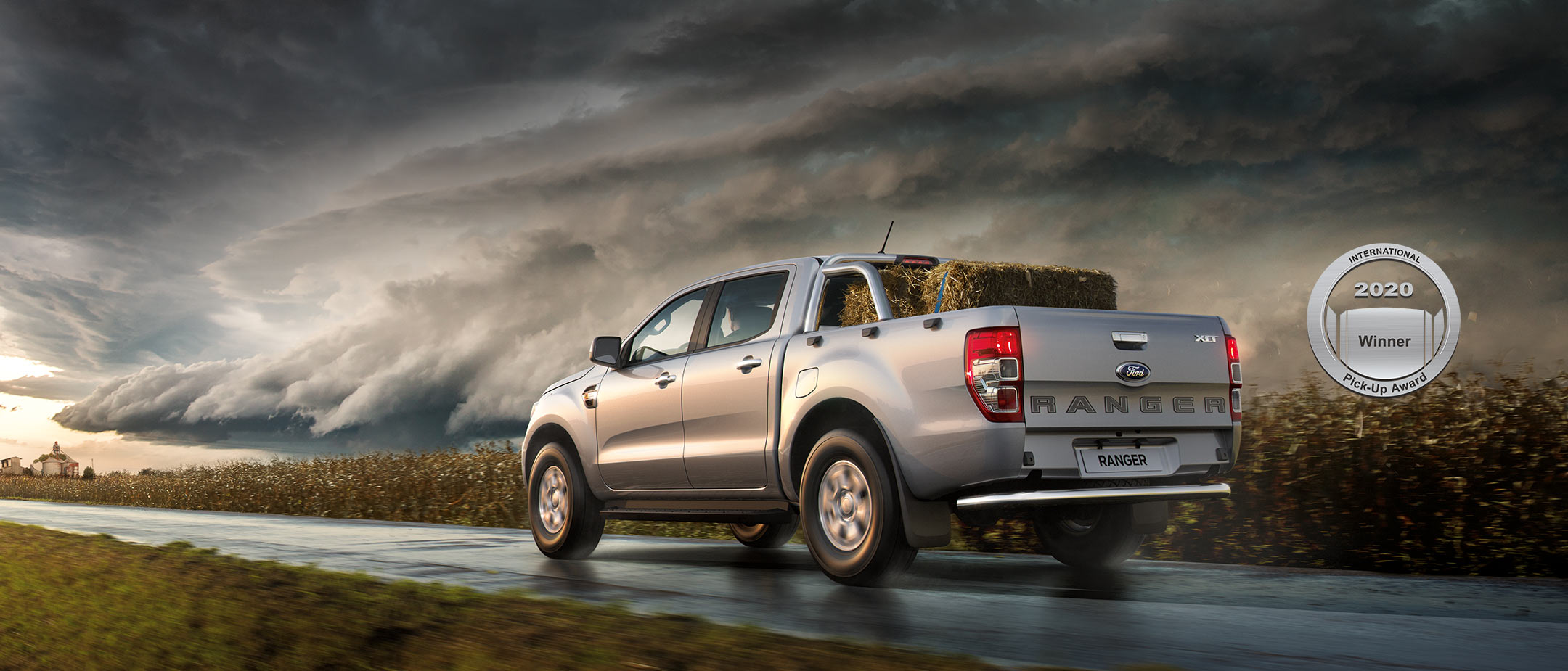 Silver Ford Ranger Wildtrak driving down country road