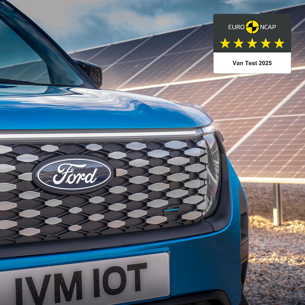 Ford E-Transit CouFord E-Transit Courier in Blau. Ansicht des Kühlergrills mit Ford-Emblem und Abbildung des NCAP-Logos.rier in Blau. Detailansicht Ford-Logo.